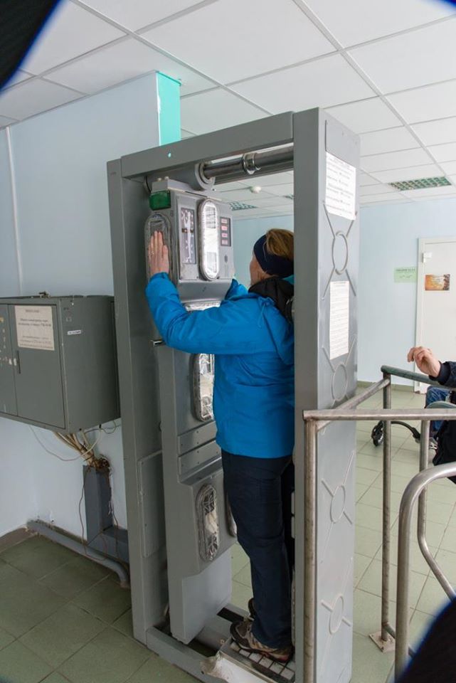 Photo of me standing in the body scanner with my hands elevated. This machine makes sure you don't have any radioactive particles on you. 