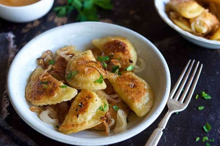 Photo of a bowl filled with Pierogi