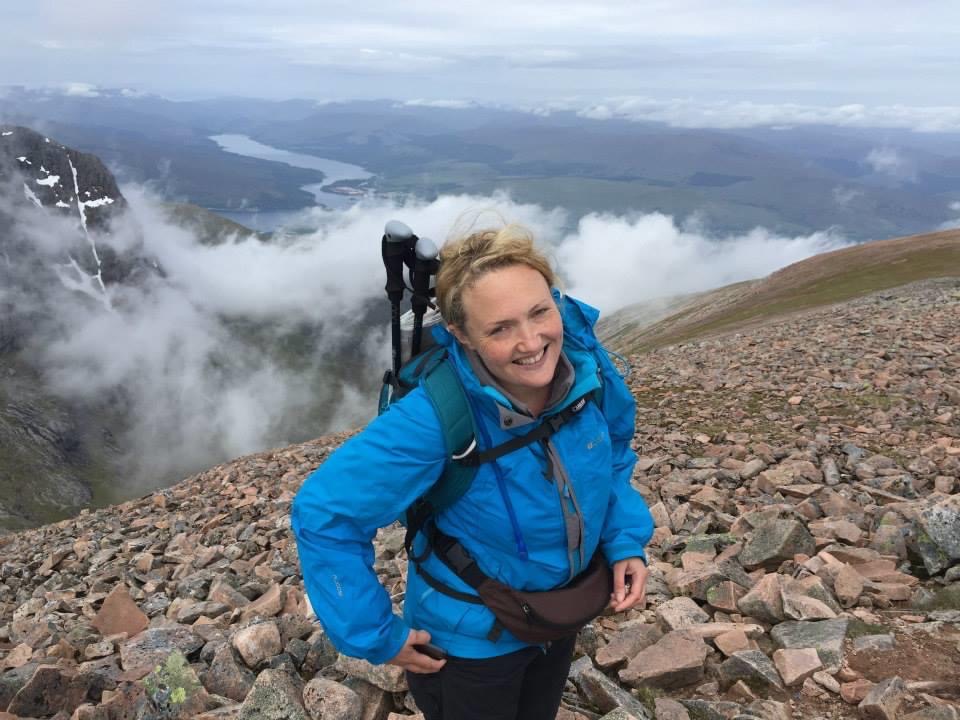 A photo of me smiling on the side of a mountain with a massive drop behind me. This was as I made my way up to Carn Mor Dearg, which would eventually get me to Ben Nevis. 