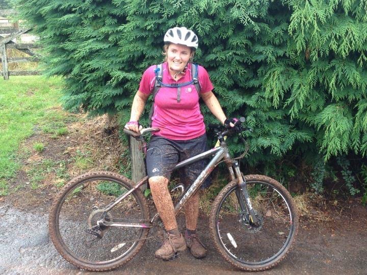 A photo of me on my mountain bike covered head to toe in mud