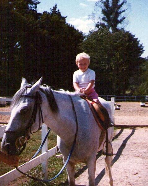 Photo of me as a kid, at a guess 2 or 3 years old, sitting on a grey horse. The picture of happiness. 