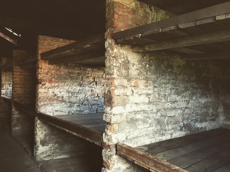 Photo of the sleeping quarters in Auschwitz Birkenau - 3 tier bunk beds. 