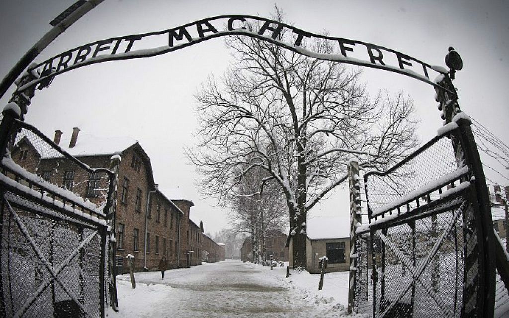 Image of the open gates leading into Auschwitz with the now famous slogan of  Arbeit macht frei "Work will set you free"