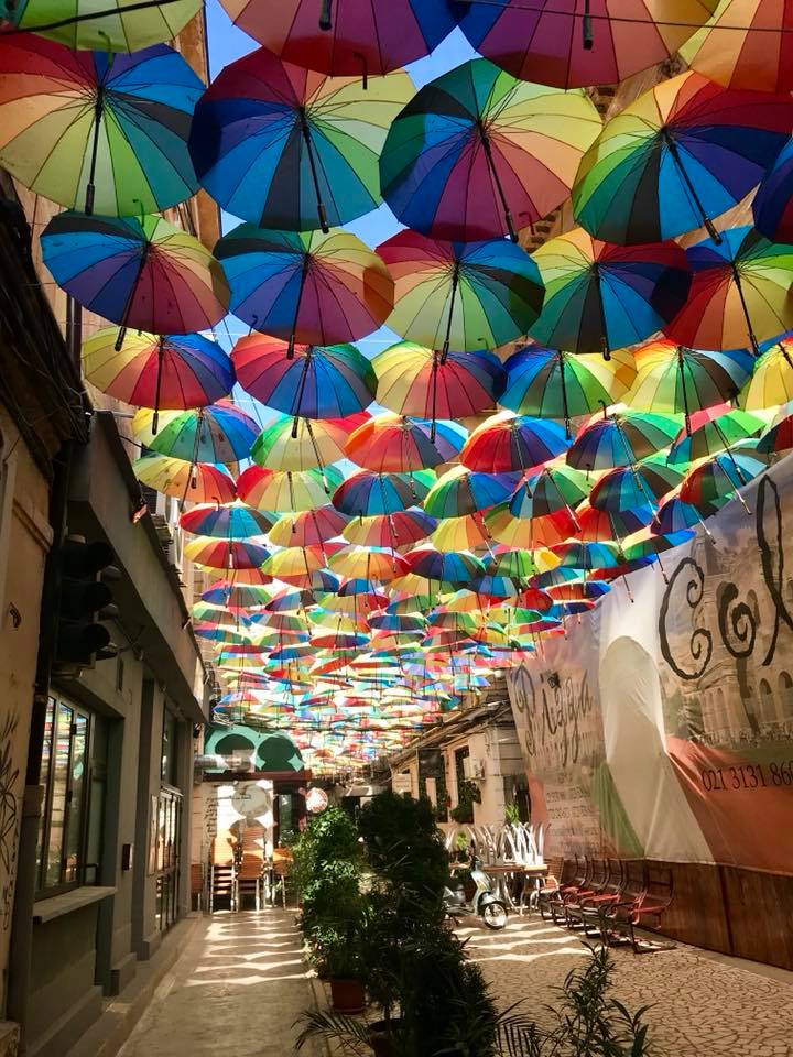 Colourful umbrellas providing shadow on a trendy street in Bucharest