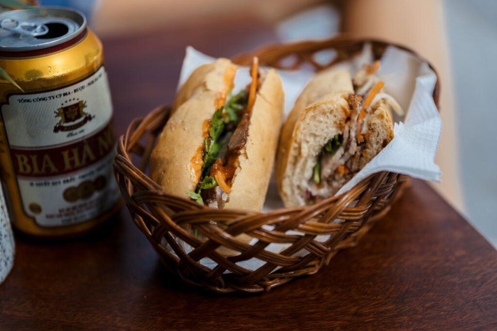 One of the top things to do in Hanoi is to enjoy a Banh Mi, a baguette with pate, meat and veg, as well as a beer. 