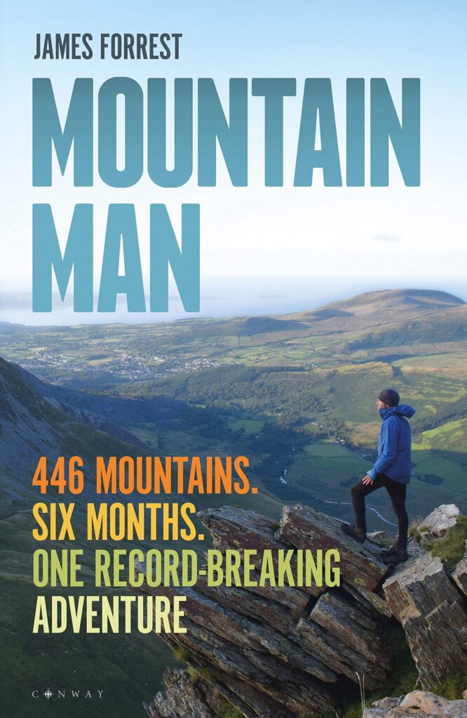 Book cover for Mountain Man showing a man standing on a rocky protrusion admiring the views