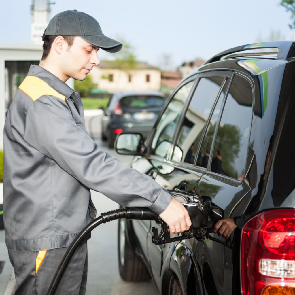 A man putting fuel in a car