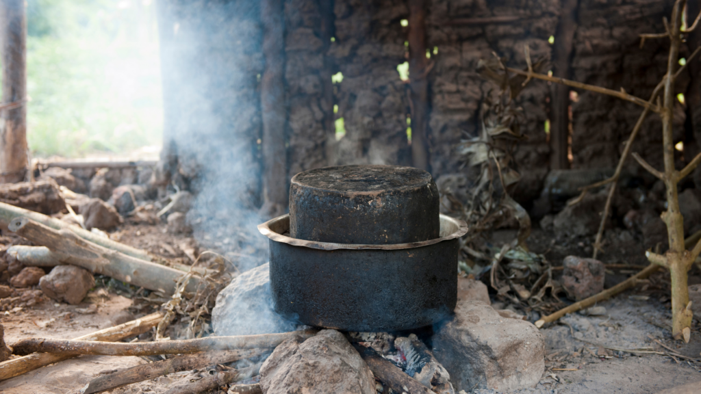 Image of a polluting cooking stove in Africa with smoke billowing out