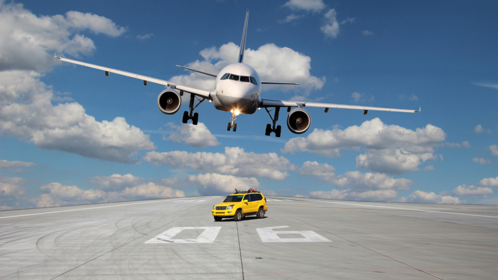 A plane flying over a car to depict the topic of conversation. What is worse when it comes to carbon emissions, the plane or the car?