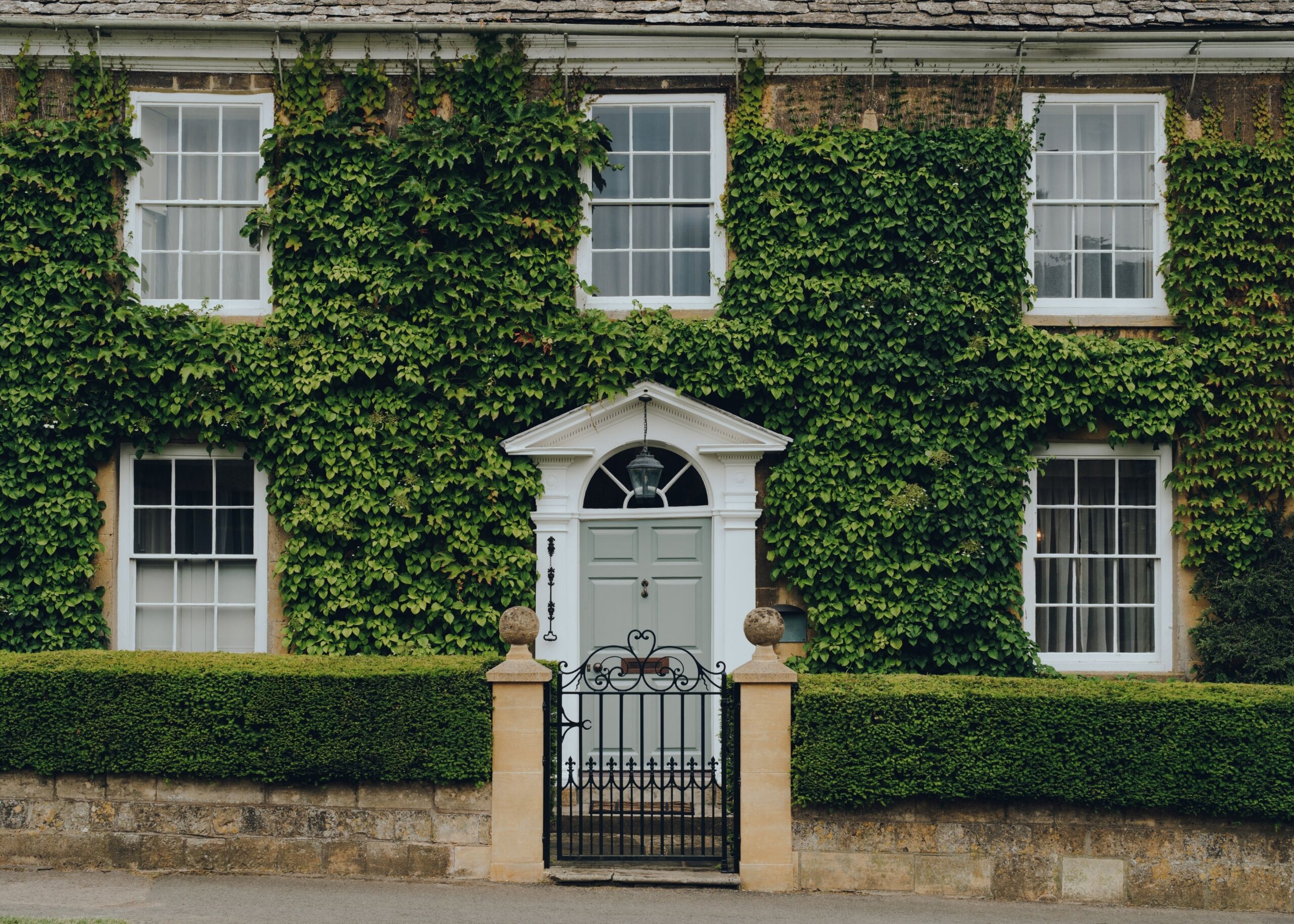 Broadway period house covered in ivy with a cute gate