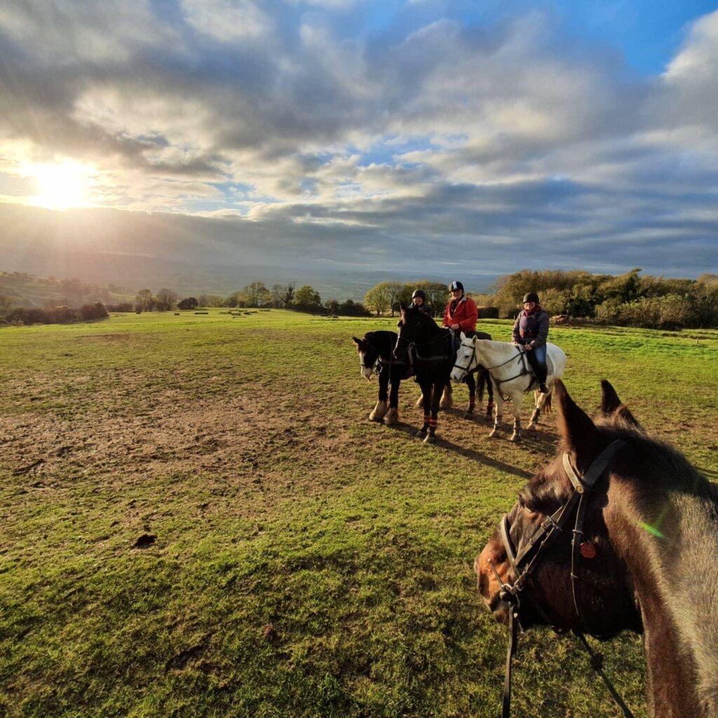 One of the best ways to experience the Broadway countryside is on horseback. Here a photo of 4 riders on their horses. 