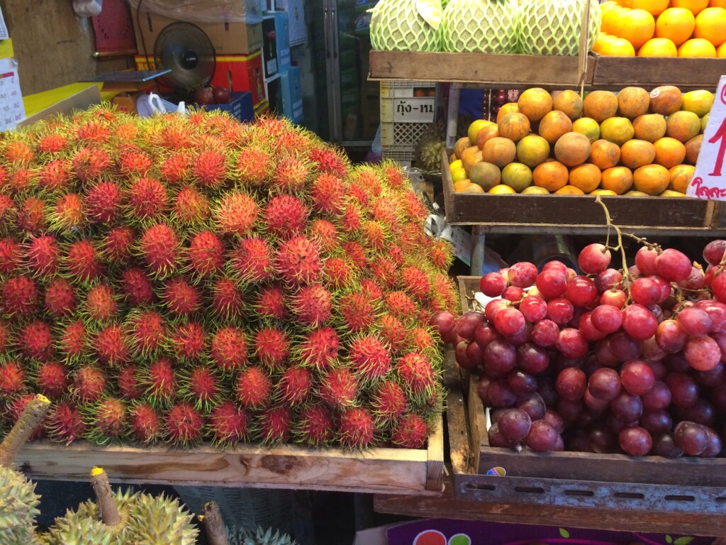 Hairy strawberries known as rambutan, some greats and some unidentifiable fruit