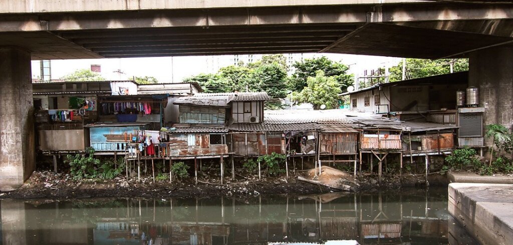 Khlong Toei Slum. Rickety tin houses sitting underneath one of the flyovers