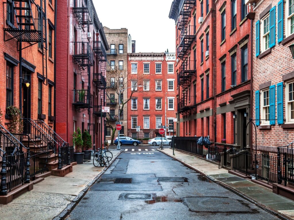 One of the many streets of Greenwich Village, with the 4 and 5 story red brick apartment blocks and famous outdoor metal fire escape stairs that are so synonymous with New York