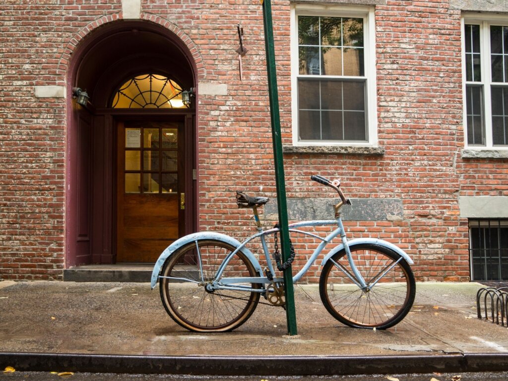 A bicycle leaning against a lamp post in Greenwich village