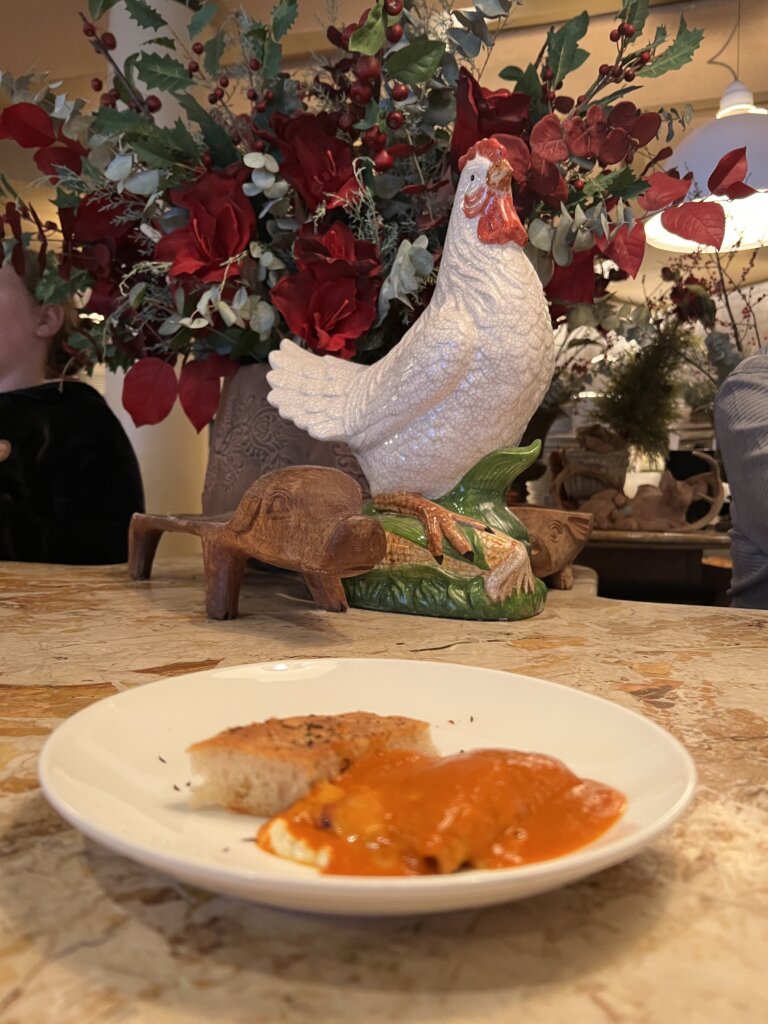 The delicious eggplant rollatini with a big chicken watching over me in the background