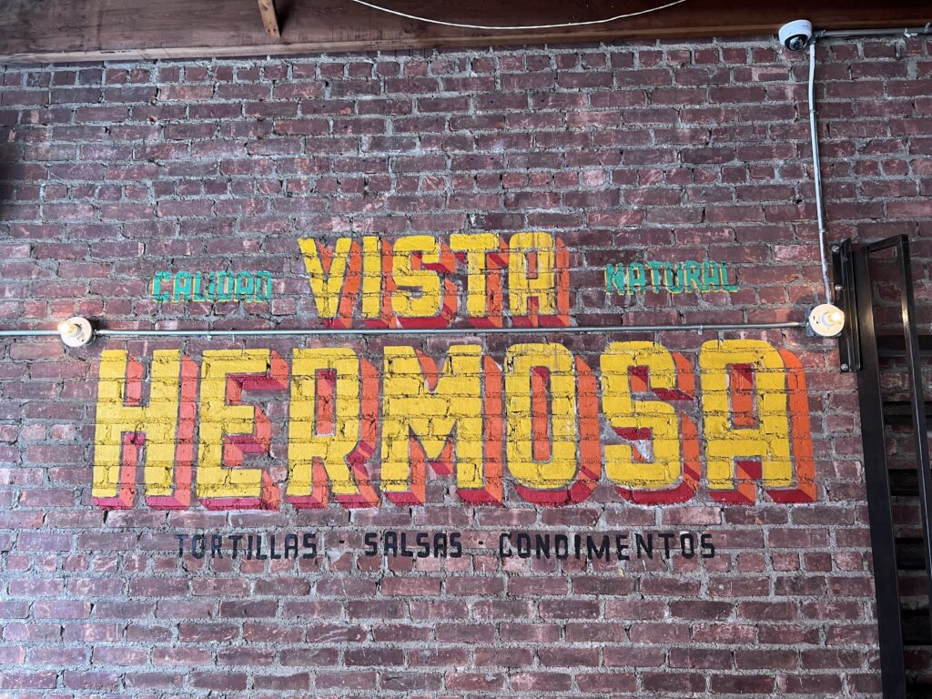 The wall of the restaurant with large wording saying "Vista Hermosa"