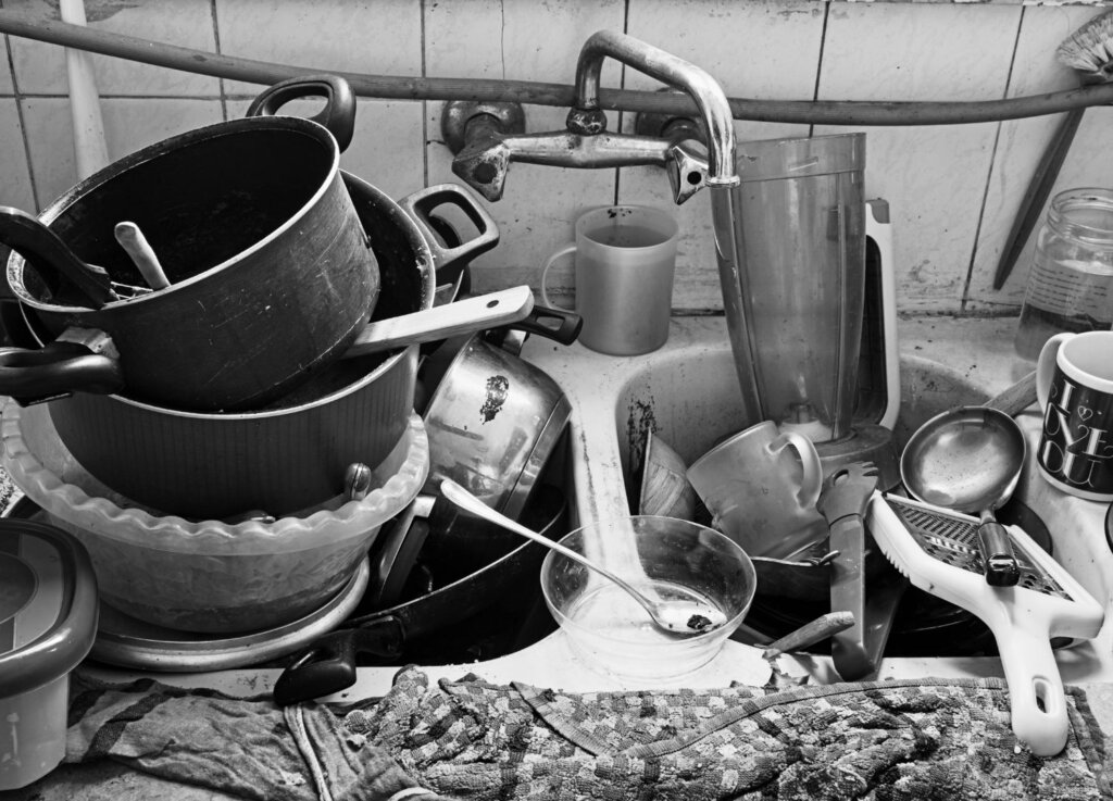 A sink full of dirty pots and pans