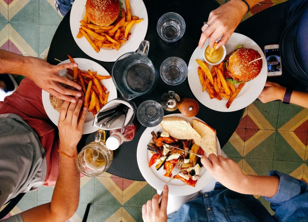 4 people eating burgers