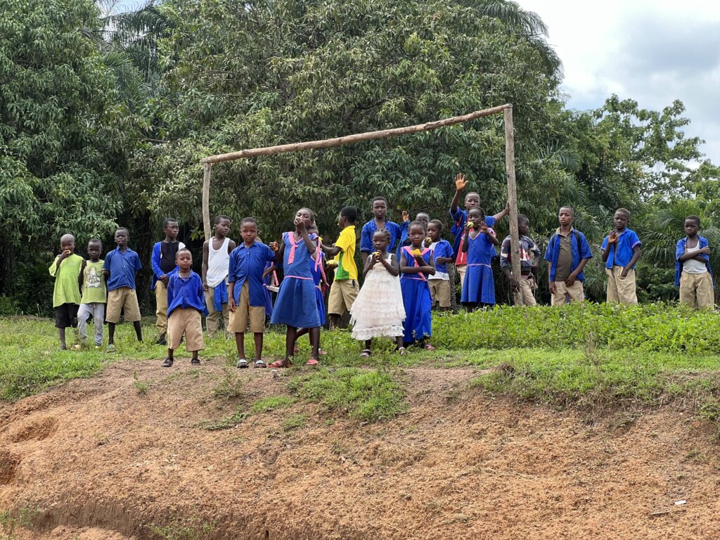 Kids waving at us from the side of the road