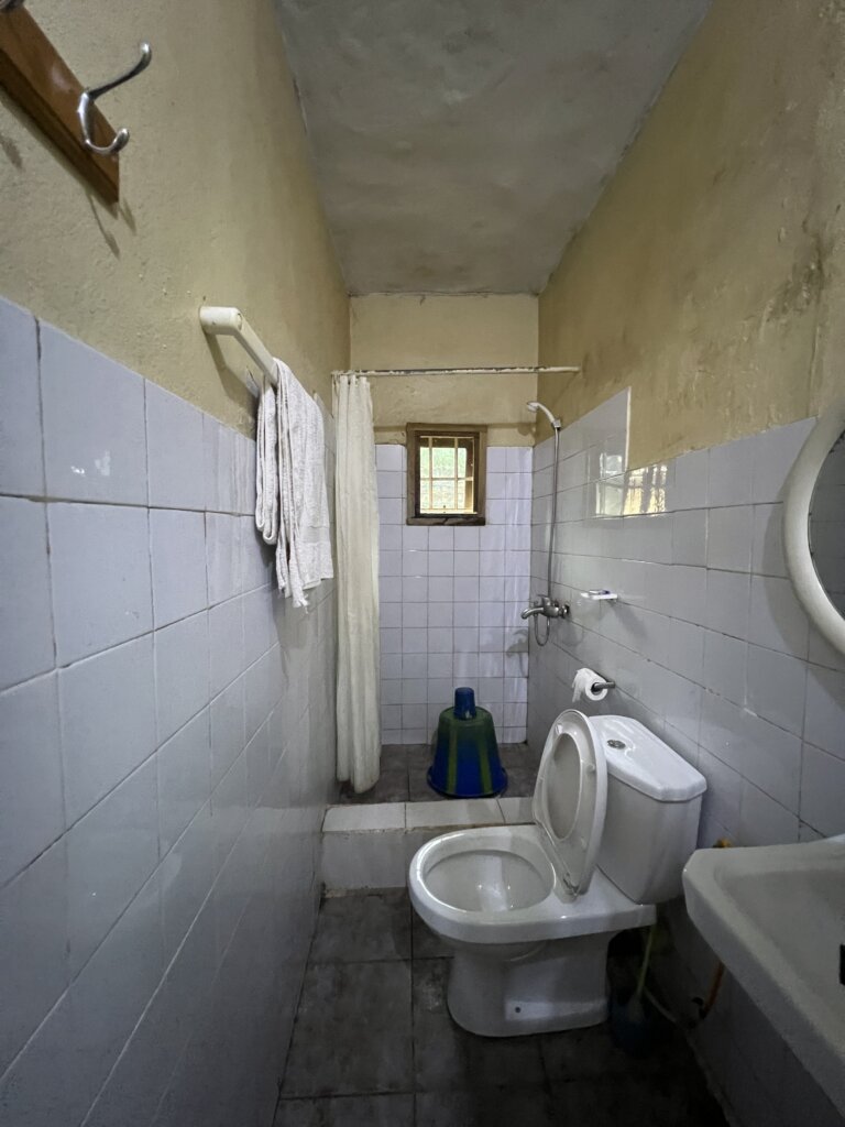 A very basic toilet with a bucket shower 