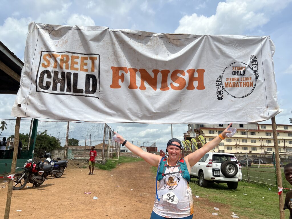 Sierra Leone marathon complete! Me in front of the finish sign! A very sweaty mess!