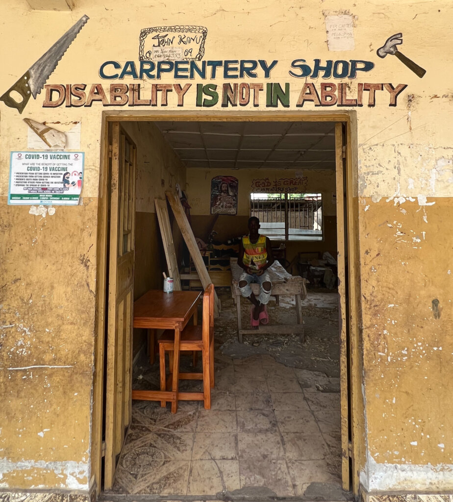 A carpentry shop in the polio camp with a slogan reading "Disability is not inability". Street Child helps fund these kind of projects