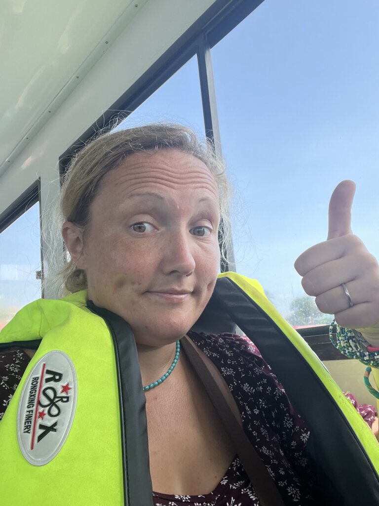 Me earing my life jacket and giving the camera a thumbs up on route to the airport for my final trip