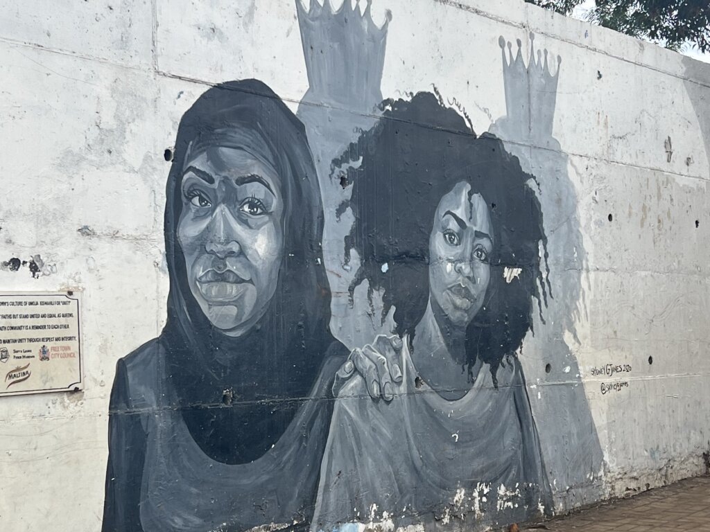 Mural in Freetown, Sierra Leone, depicting a Muslim woman and a Christian woman, a sign of friendship