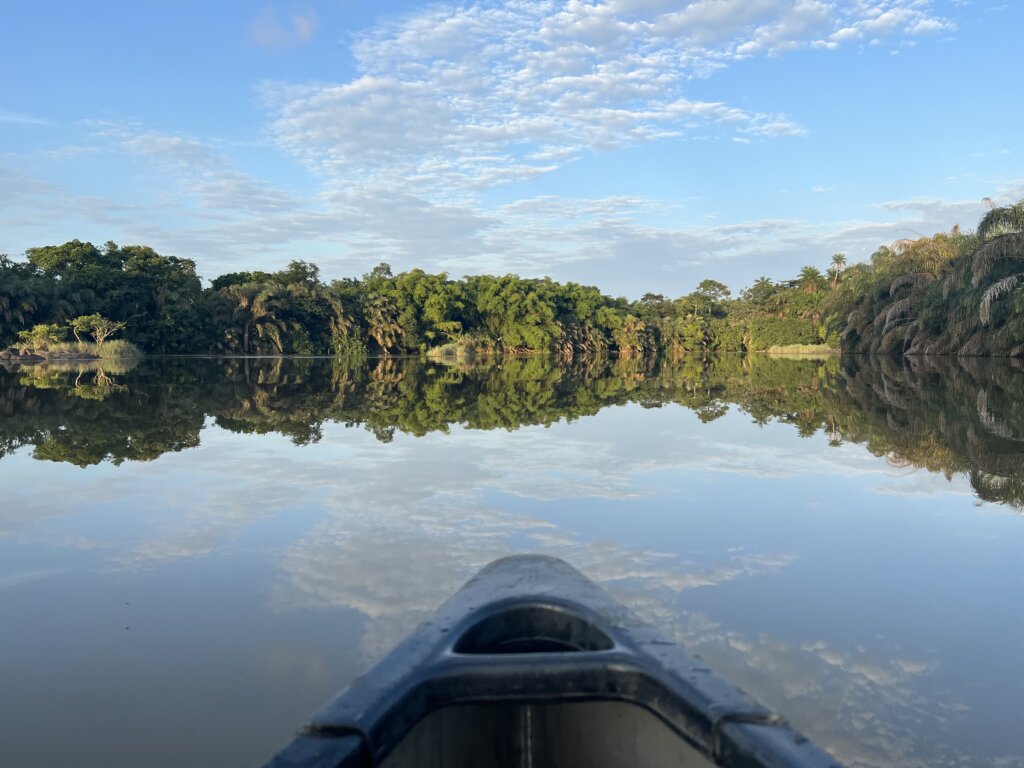 The point of our canoe pointing at the perfect mirror, al the trees and clouds perfectly reflected 