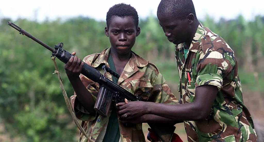 A child soilder holding an AK47