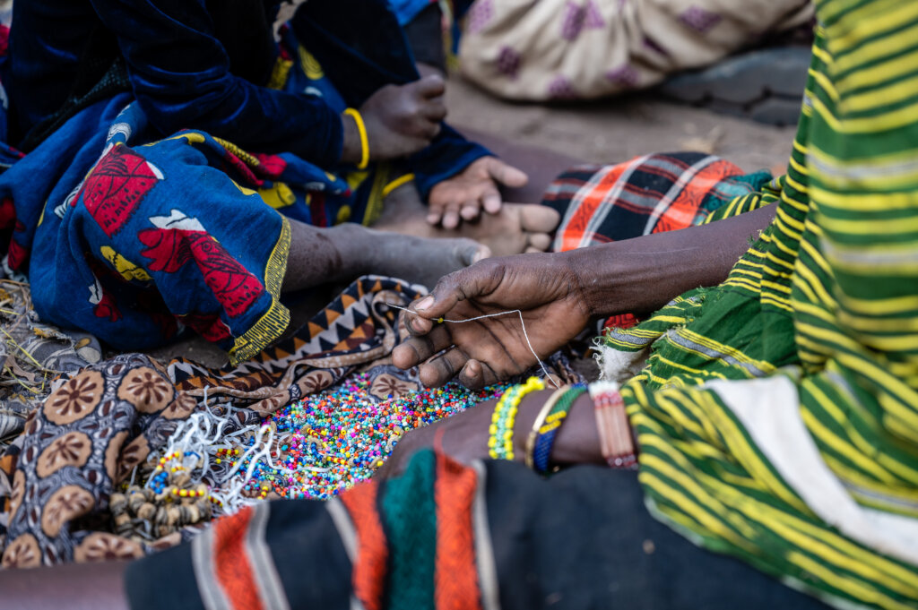 Women make bracelets to sell 