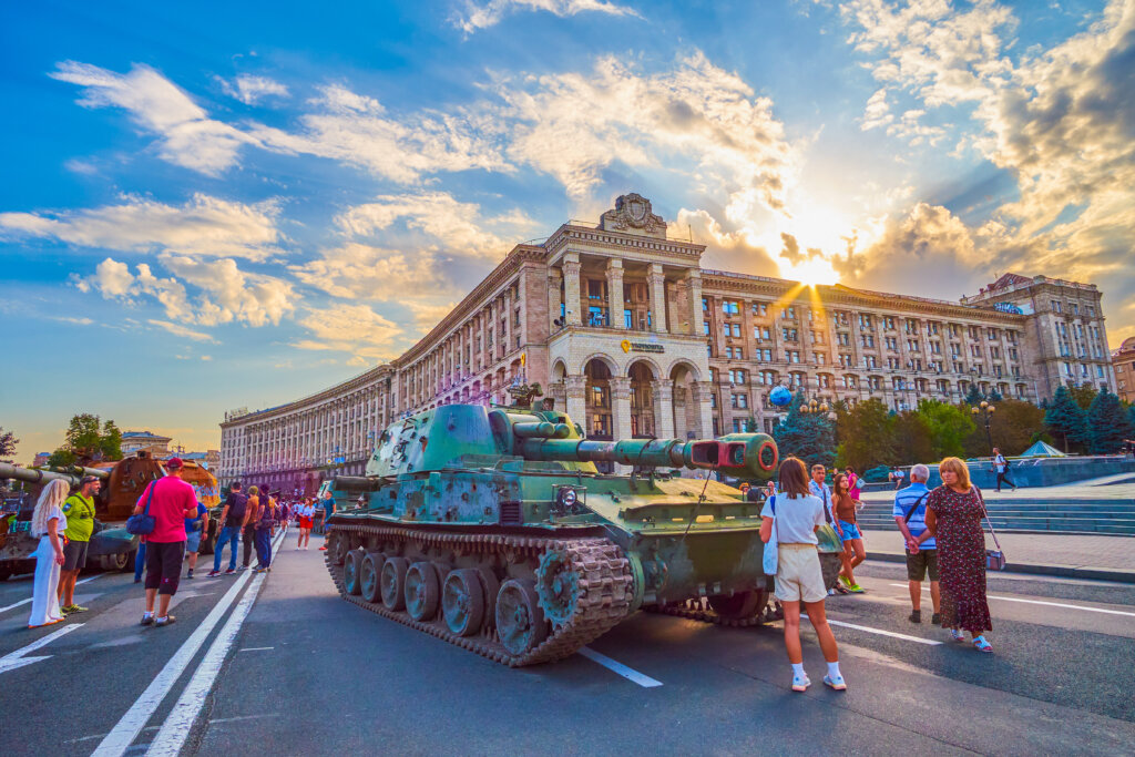 Crowd gathers around a broken russian military vehicle