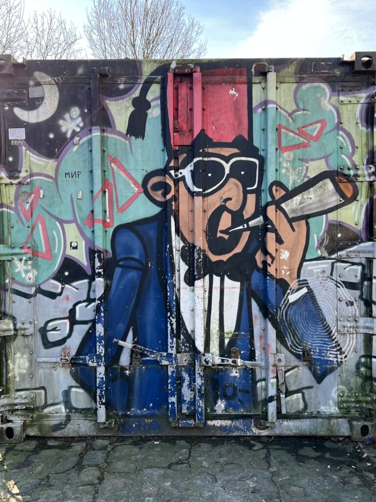 A container painted with a man in a tuxedo smoking a spliff