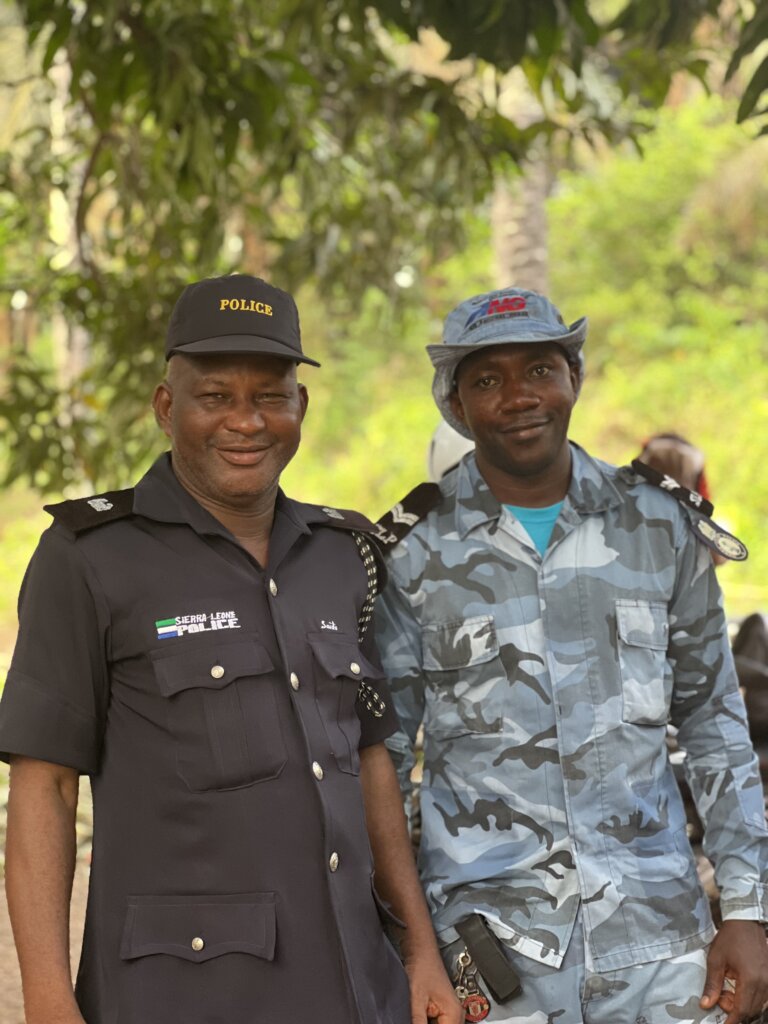 Two smiling police officers smile for the camera