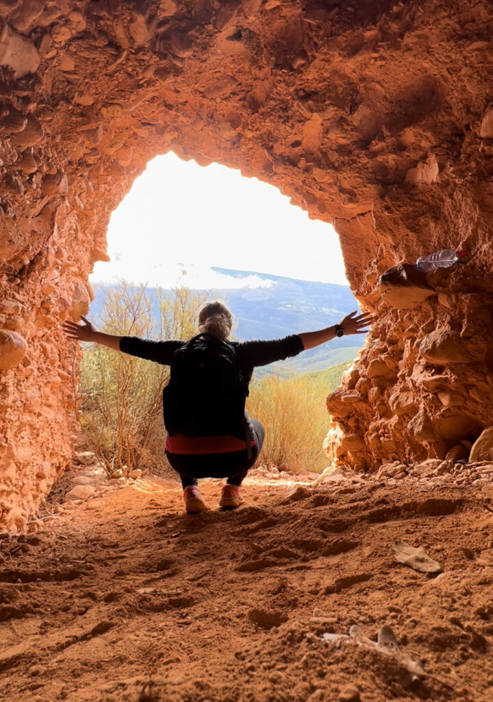 Me posing inside a red rock cave in Las Medulas - a real hidden gem in Spain