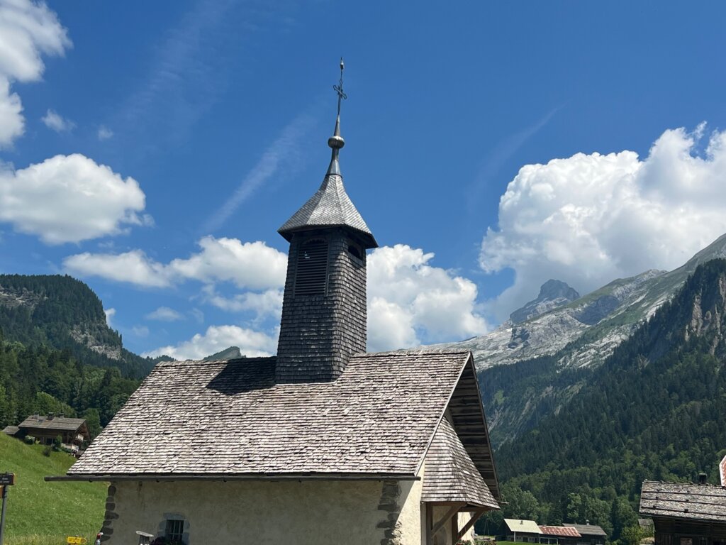 A tiny church with a backdrop of mountains