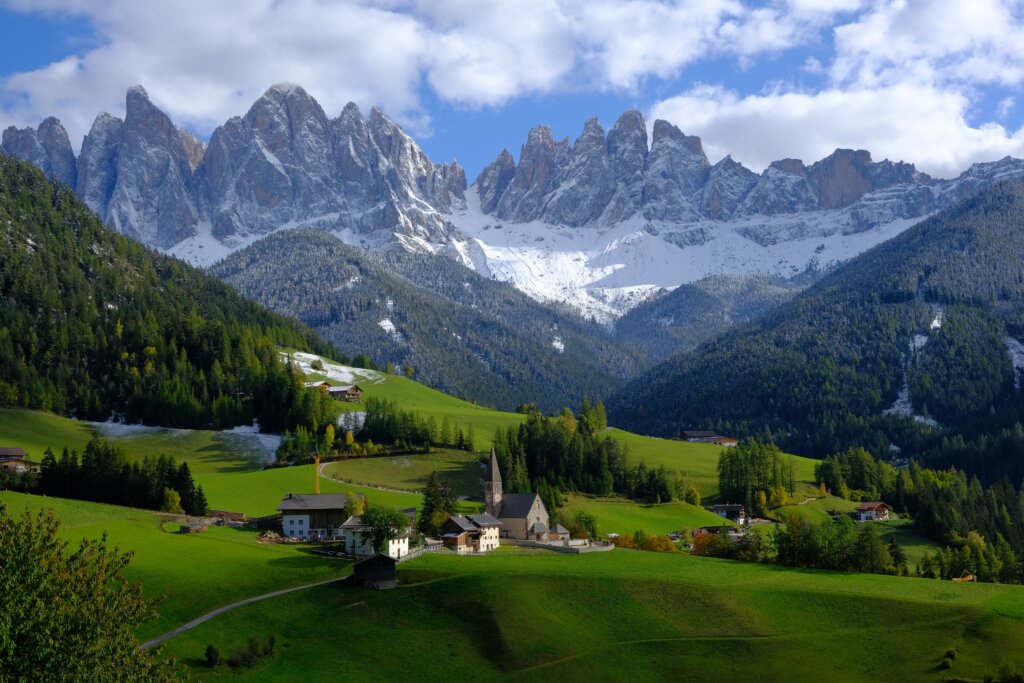 Small little village surround by the staggering Dolomite peaks