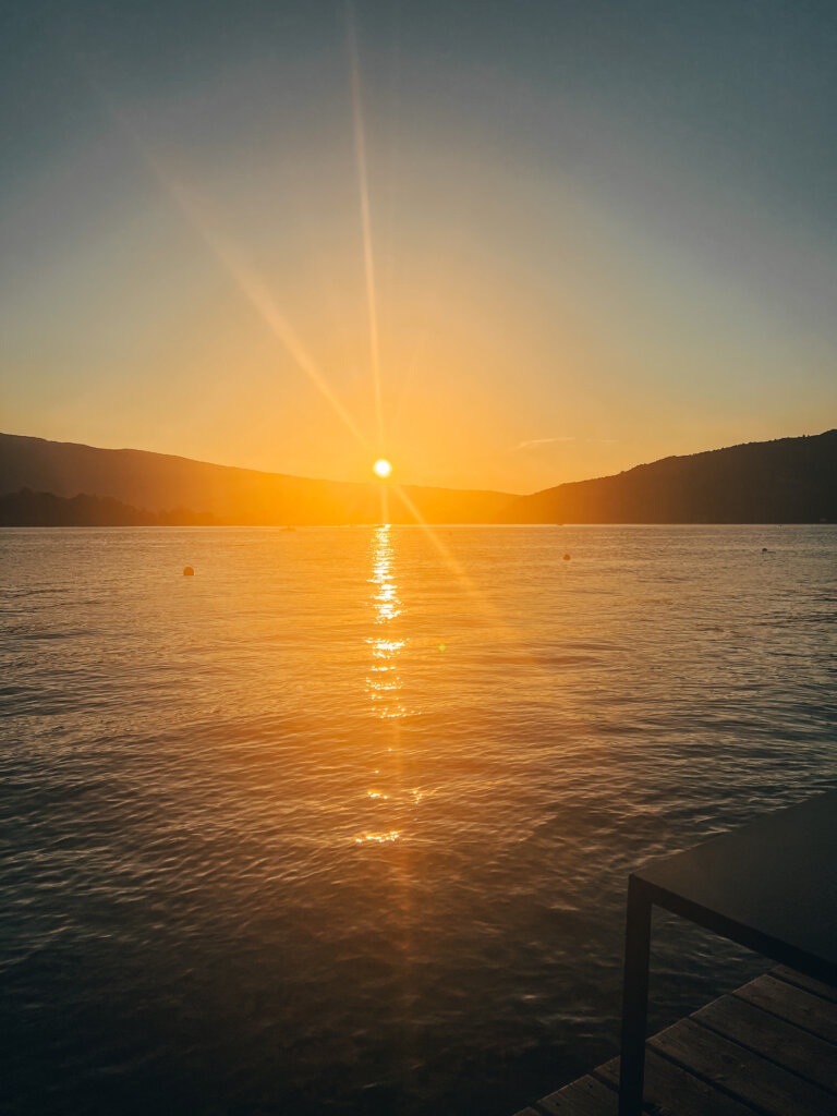 Sun setting across Lake Annecy as seen from Guinguette des Cassines a Angon - one of the best thing to do