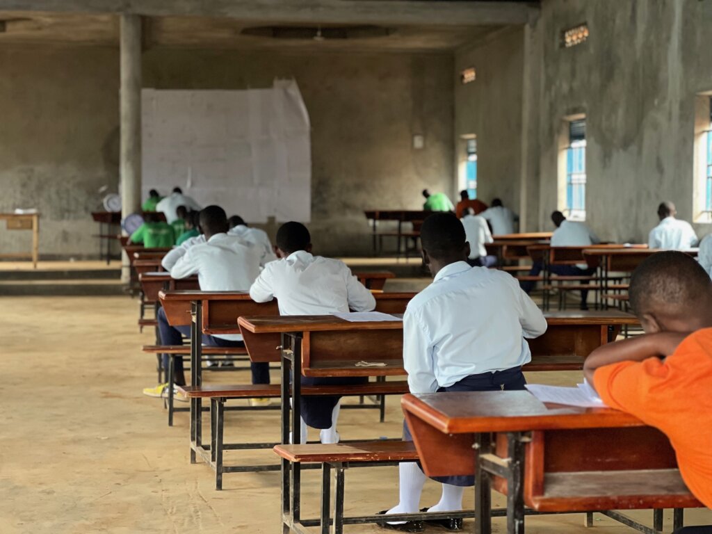 School kids sit their exams in a large concrete building