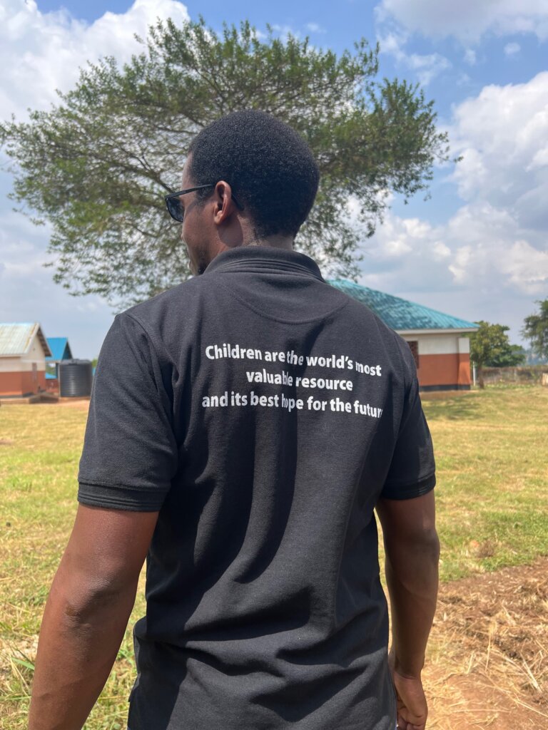 A man wearing a t-shirt that says "Children are the world's most valuable resource and its best hope for the future"