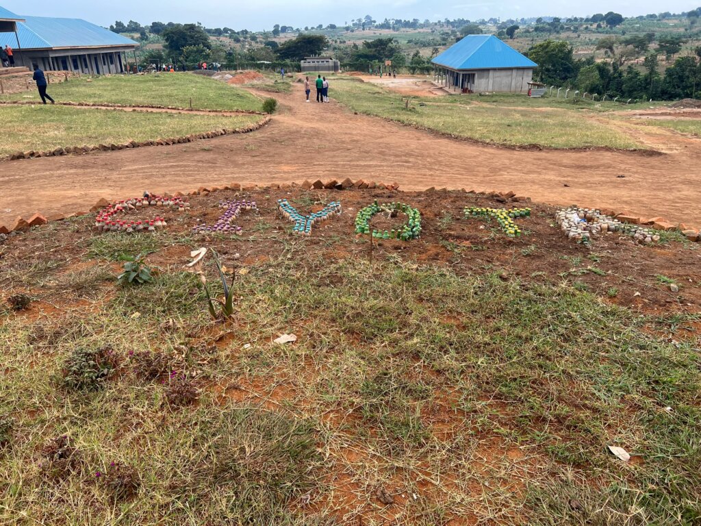 A CYOTA sign made in the red dirt using plastic bottles