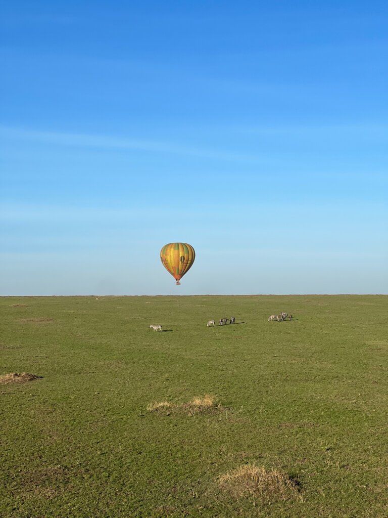 Balloon ride over the Maasai Mara with zebras crossing underneath