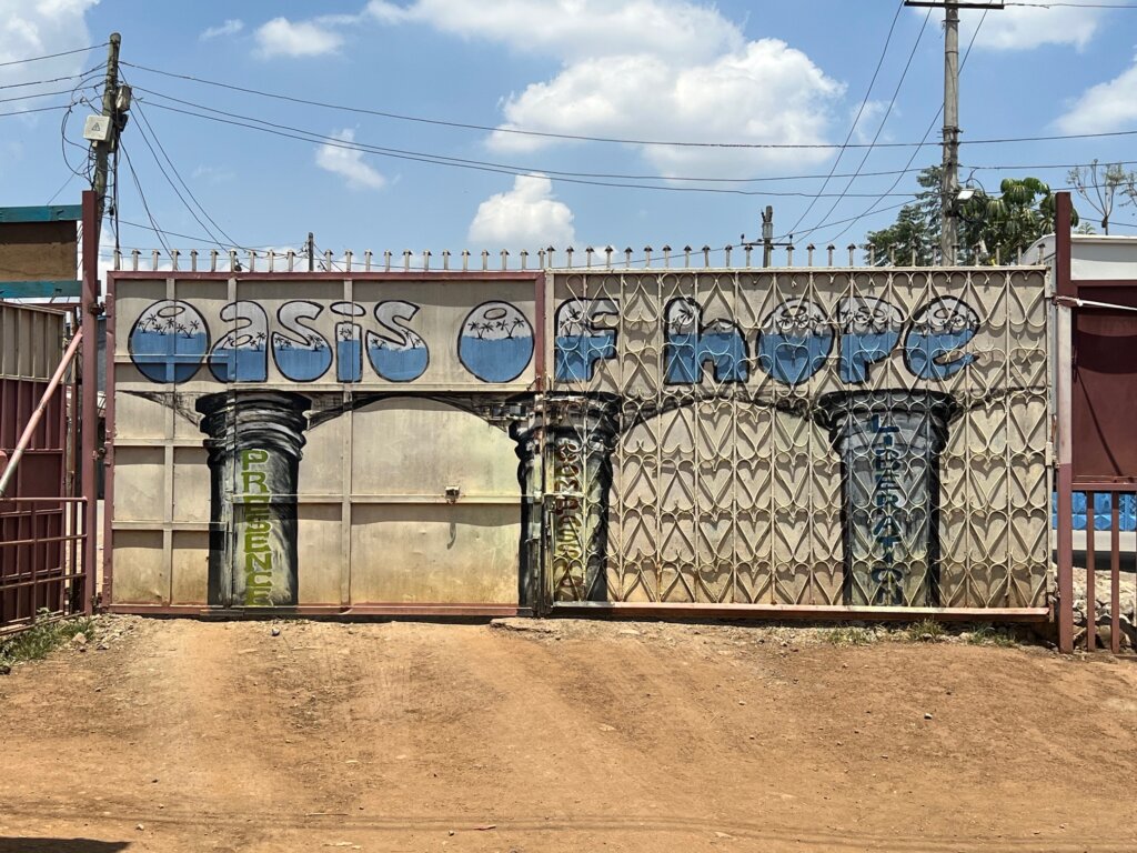 Oasis of Hope, graffiti painted on the gates of the Ruben Centre