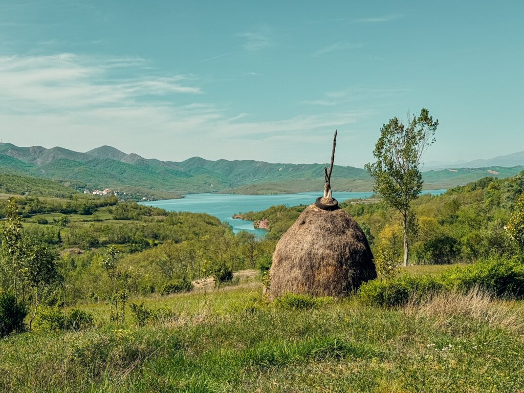 A hay mound overlooking a lake