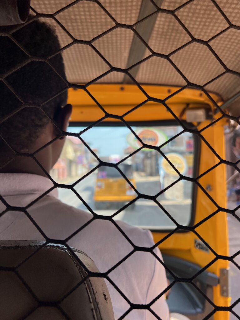 Sitting in the back of a keke