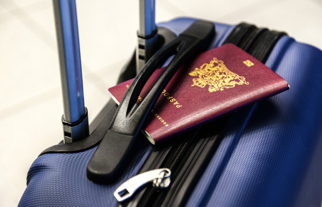 Passport resting on a wheelie bag
