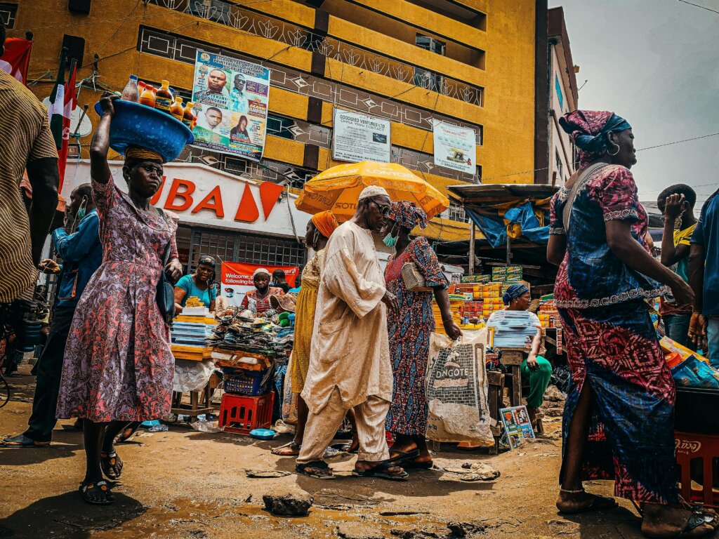 African market, lots of colourful people walking about