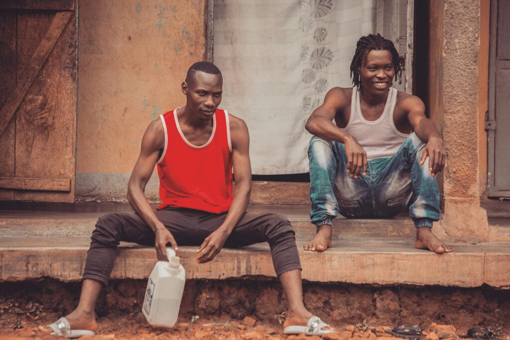 Two men sitting outside their home in the Katanga Slums