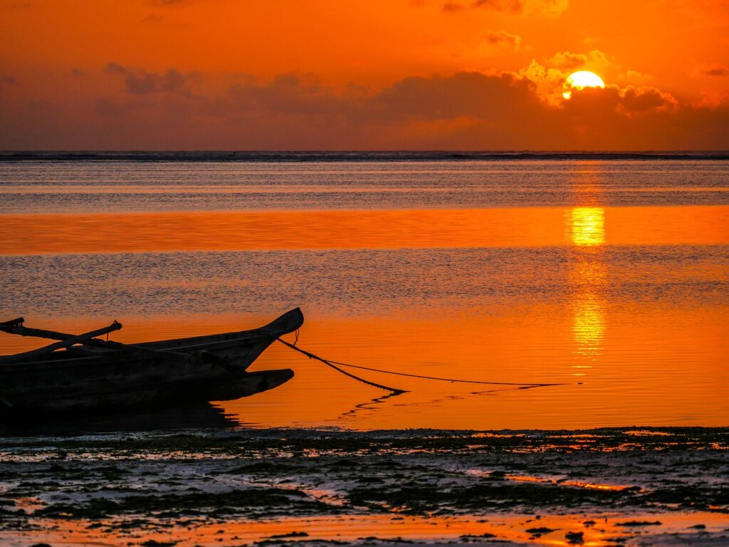 Sunset photo of a fishing boat moored on the coast of Zanzibar